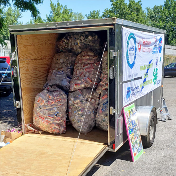 full bags of cans stuffed inside the trailer