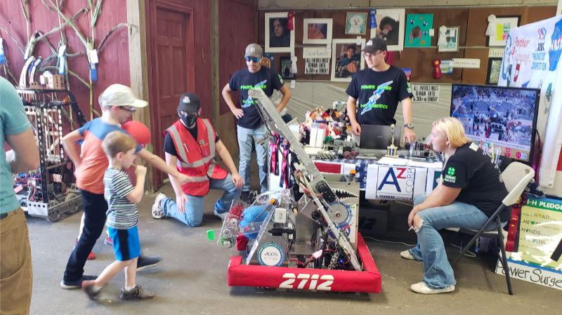 children catch balls tossed by our robot at the team's booth at the Bethlehem Fair