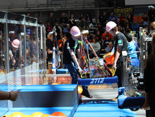 Drive team placing robot on game field during competition