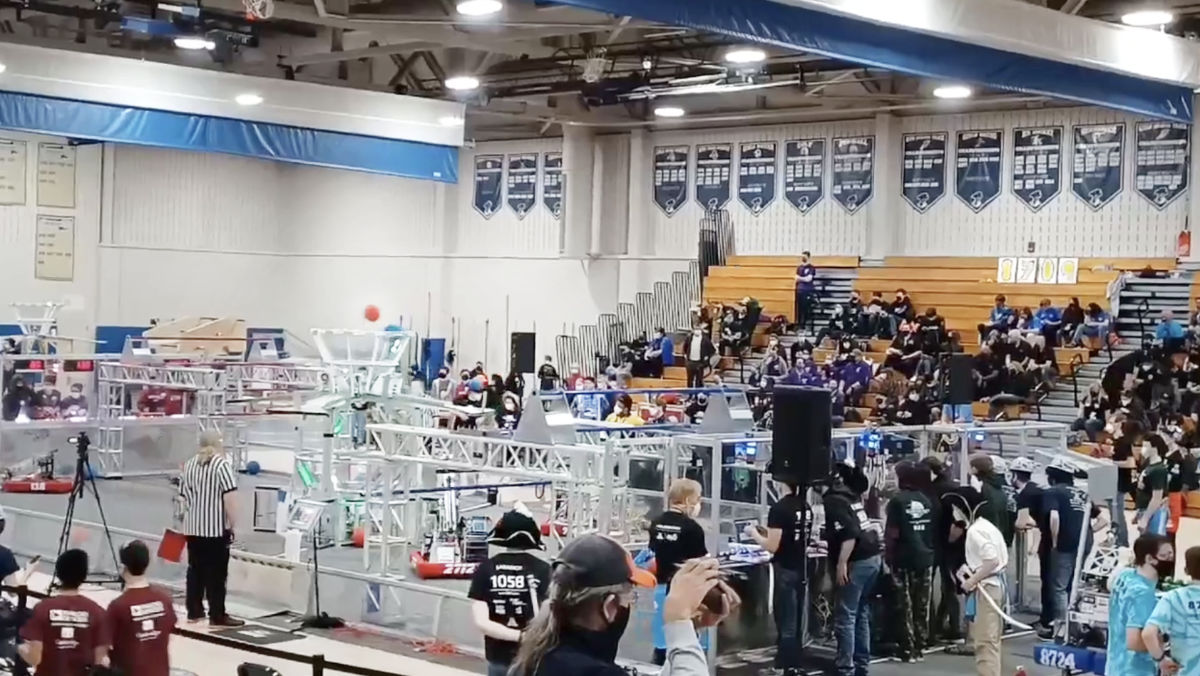 FIRST competition field in high school gym with spectators in stands