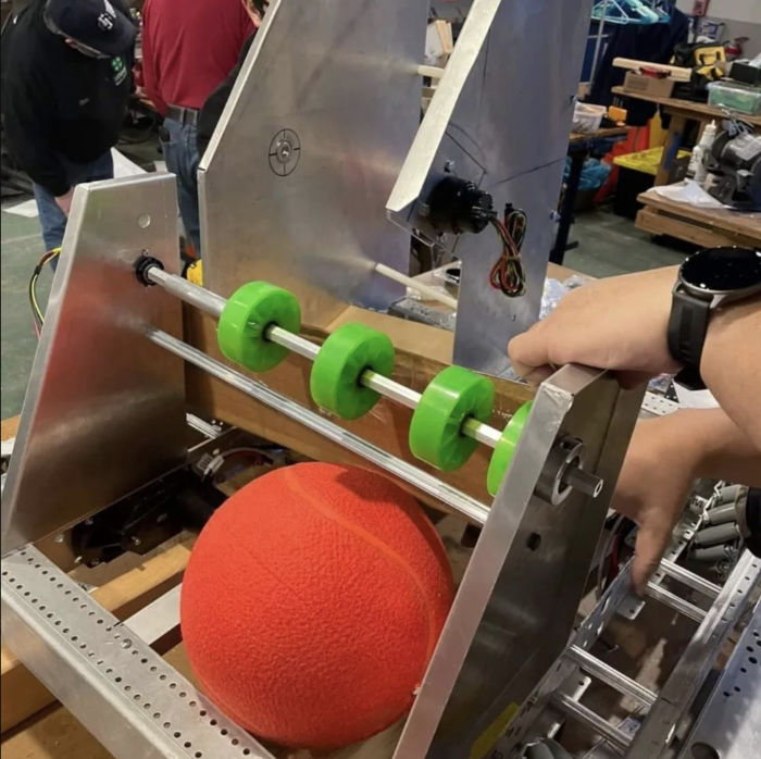close up of game ball in shooting mechanism on robot