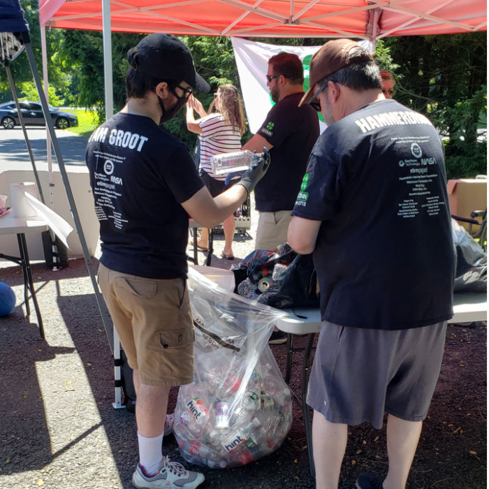 students sorting cans and bottles at table