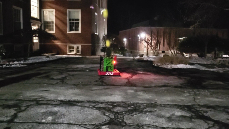 Darth Ziptie robot launching game pieces in the parking lot one evening. (It can shoot quite a distance!)