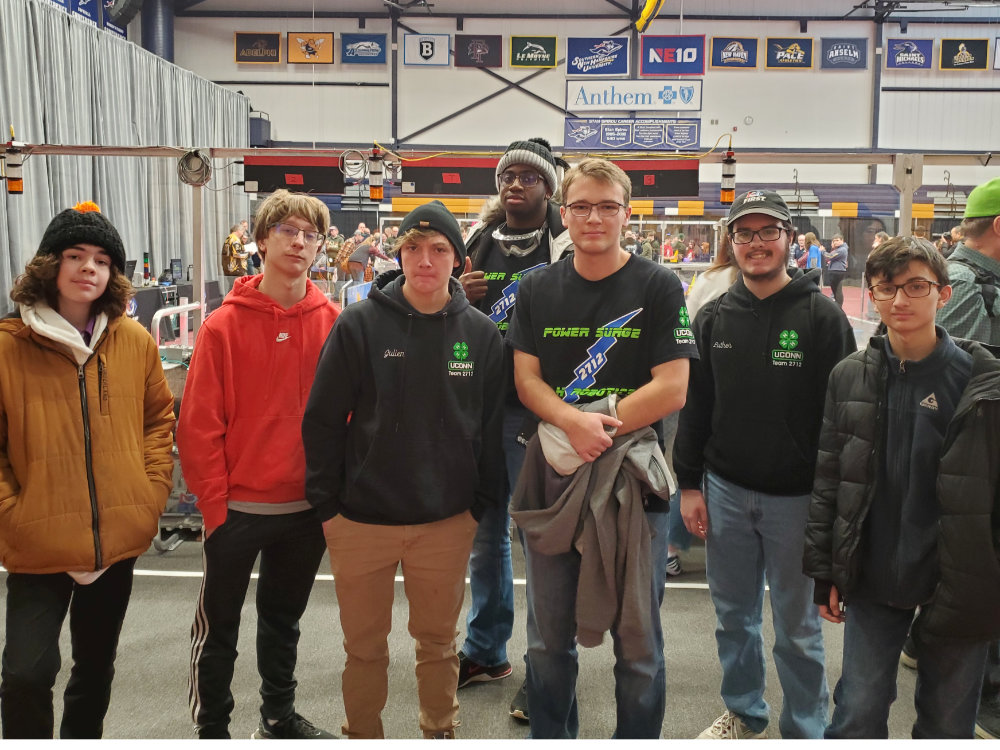 Seven Power Surge team students standing near the competition field at FIRST Kickoff 2023